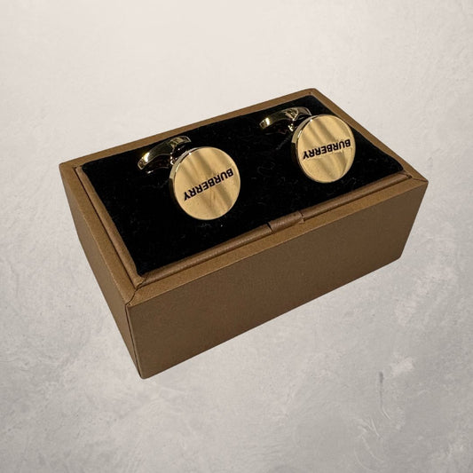 Gouden manchetarmbanden van Burberry met doos.